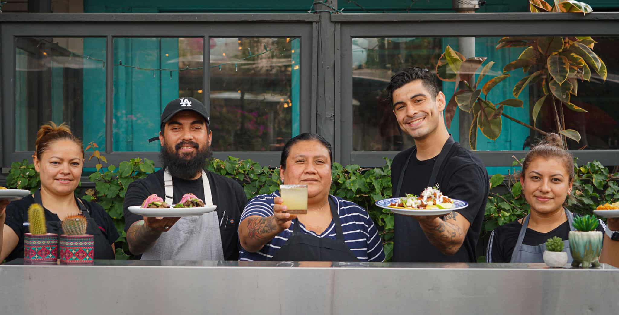 Tallula's Taco Cart with Chefs holding up dishes & drinks